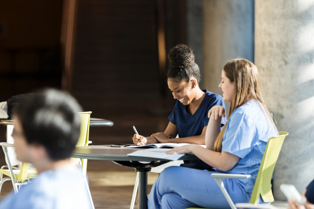 Young adult female nursing students enjoy studying together